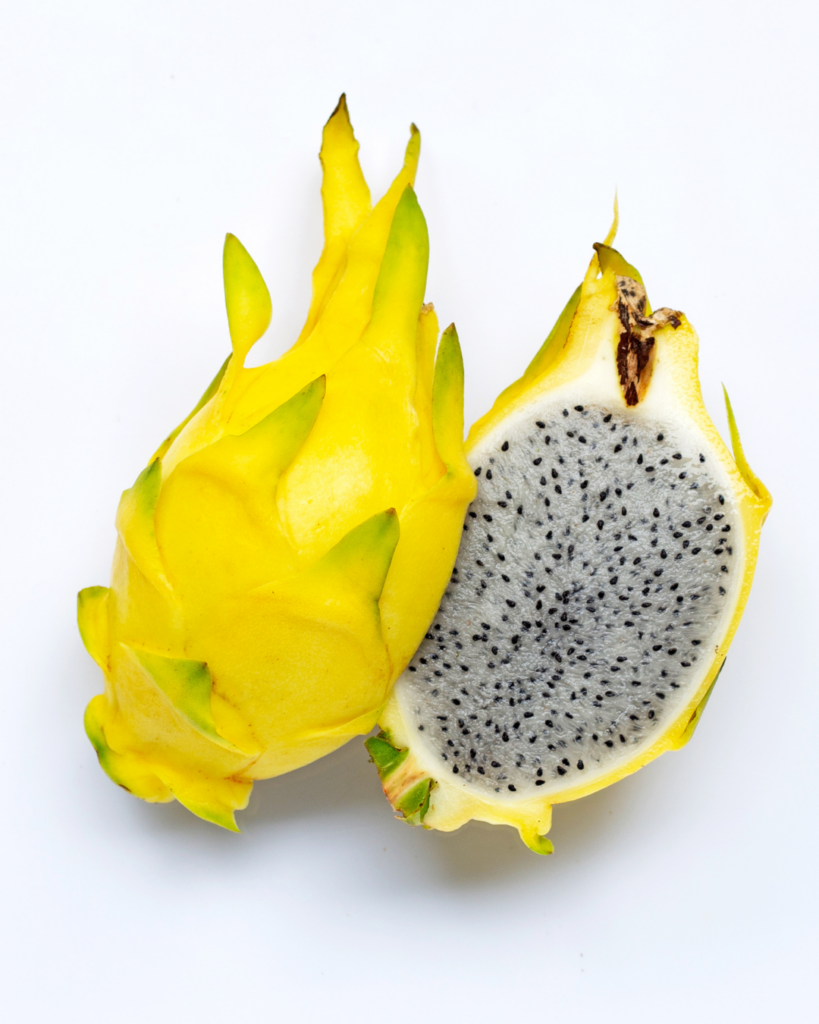 Sliced yellow dragon fruit with golden bumpy skin.